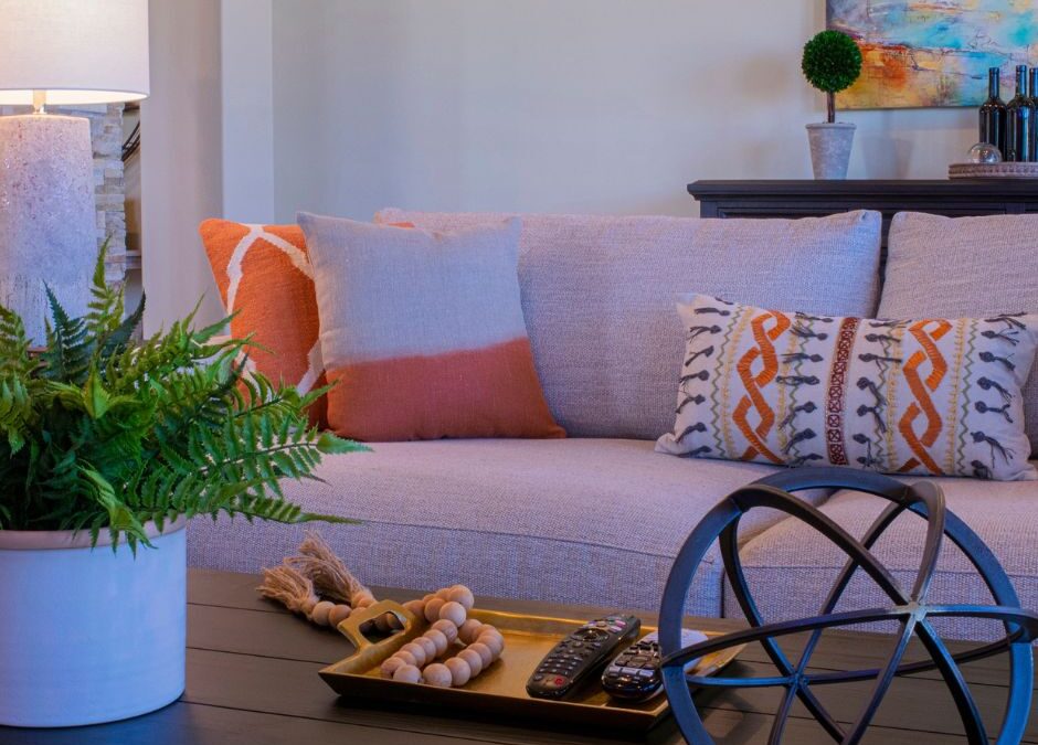 Warm, inviting living room with comfortable seating, natural greenery, and calming décor that creates a peaceful atmosphere